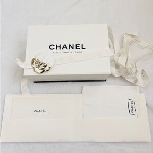 Chanel box with booklet, cleaning cloth, flower on ribbon and tissue